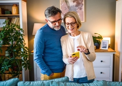 Mature couple using mobile phone